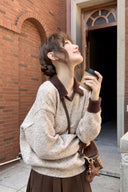Marlowe petite faux-layer sweater in oatmeal with cocoa contrast collar and cuffs, model holding a coffee cup