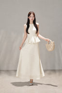 Front view of the VOGSION Mirelle Apricot sleeveless petite A-line maxi dress with a peplum waist.