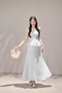 Front view of the VOGSION Mirelle Light Blue sleeveless petite peplum maxi dress with an A-line skirt.