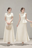 Two models wearing the VOGSION Mirelle petite faux two-piece peplum maxi dress in Apricot, shown in Puff Sleeve and Sleeveless styles.