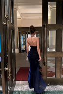Back view of navy blue halter evening gown with fitted ruched bodice