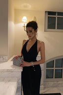 Close view of navy blue shimmer halter maxi dress styled for a formal evening