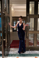 Navy blue wedding guest maxi dress with deep V halter neckline and draped front