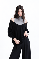 Nerine layered knit two-piece set with relaxed black sweater and grey mock-neck top, close-up view