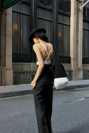 Rear view of the VOGSION Nocturne two-piece pants set showing crossed back straps and black wide-leg trousers