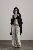 Model wearing ivory and black Gothic beaded wide-leg pants in a full front view