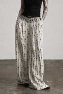 Close-up of the V-shaped waistband and black bead fringe