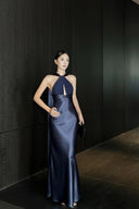 Navy blue evening maxi dress with open back and lustrous finish