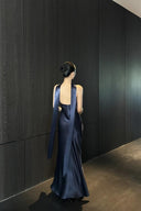 Back view of navy blue open-back formal maxi dress