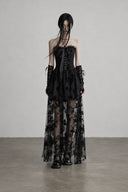 Front view of black gothic corset dress with sheer floral maxi overlay