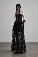 Three-quarter view of black strapless gothic dress and lace arm warmers