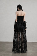 Back view of black gothic corset dress with smocked bodice and mesh overlay