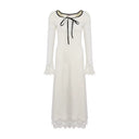 Ivory petite A-line maxi dress on a white background showing the long sleeves, black bow and lace-trim hem