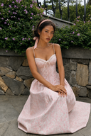     Vogsion blush pink floral corset dress styled with pink ribbon headband in natural outdoor light