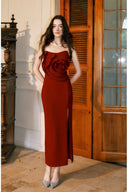 Front view of VOGSION Rosamonde burgundy strapless maxi wedding guest dress with fixed 3D rose bodice and thigh slit