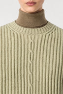 Close-up of the wide ribbed crew neckline and cable detail on the Sélise wool sweater