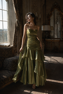 Front view of Vogsion Seraphina green wedding guest dress with twisted ruched neckline