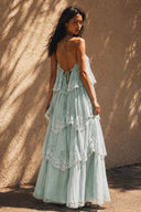 Back view of the Vogsion Seraphina Tiered Chantilly Lace Maxi Dress in soft mint green featuring an elegant open-back design, adjustable crisscross spaghetti straps, cascading Chantilly lace tiers, flowing romantic silhouette, perfect for summer weddings, garden parties, resort vacations and fairycore-inspired occasions.