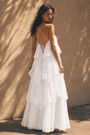 Back view of the Vogsion Seraphina Tiered Chantilly Lace Maxi Dress in white with adjustable crisscross straps, open back design, cascading Chantilly lace tiers, dreamy bridal shower, beach wedding and vacation-ready maxi dress.