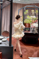 Back view of VOGSION Solène ivory ruched puffy mini dress