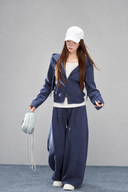 Sorelle petite navy two-way zip hoodie and matching wide-leg pants styled with a shoulder bag.