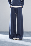 Close-up of Sorelle navy wide-leg pants showing the drawstring waist, front pleats and side pockets.