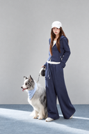 Angled view of the Sorelle petite navy hooded jacket and wide-leg pants with functional pockets.