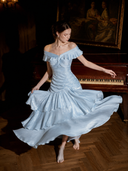 Light blue satin off-shoulder wedding guest maxi dress with tiered ruffle hem, twirl view