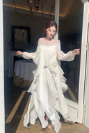 VOGSION white long sleeve maxi dress with layered petal ruffles and crystal illusion neckline, full front view