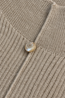 Close-up of wool-blend knit texture and decorative neckline button