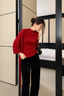 Red mock-neck knit tank with matching cardigan draped over one shoulder